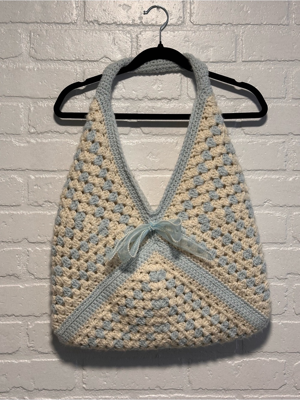 Handmade crochet tote bag with bow detail.